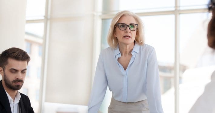 Serious mature businesswoman talk having discussion during brief